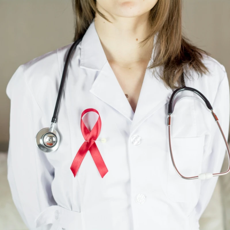 Woman doctor holding red ribbon HIV, world AIDS day awareness ribbon. More of my photos and videos Adobe Stock:http://bit.ly/3RqlciK More of my photos and videos Shutterstock: https://www.shutterstock.com/g/ALEKSANDRBERDYUGIN My email: bermix999@gmail.com